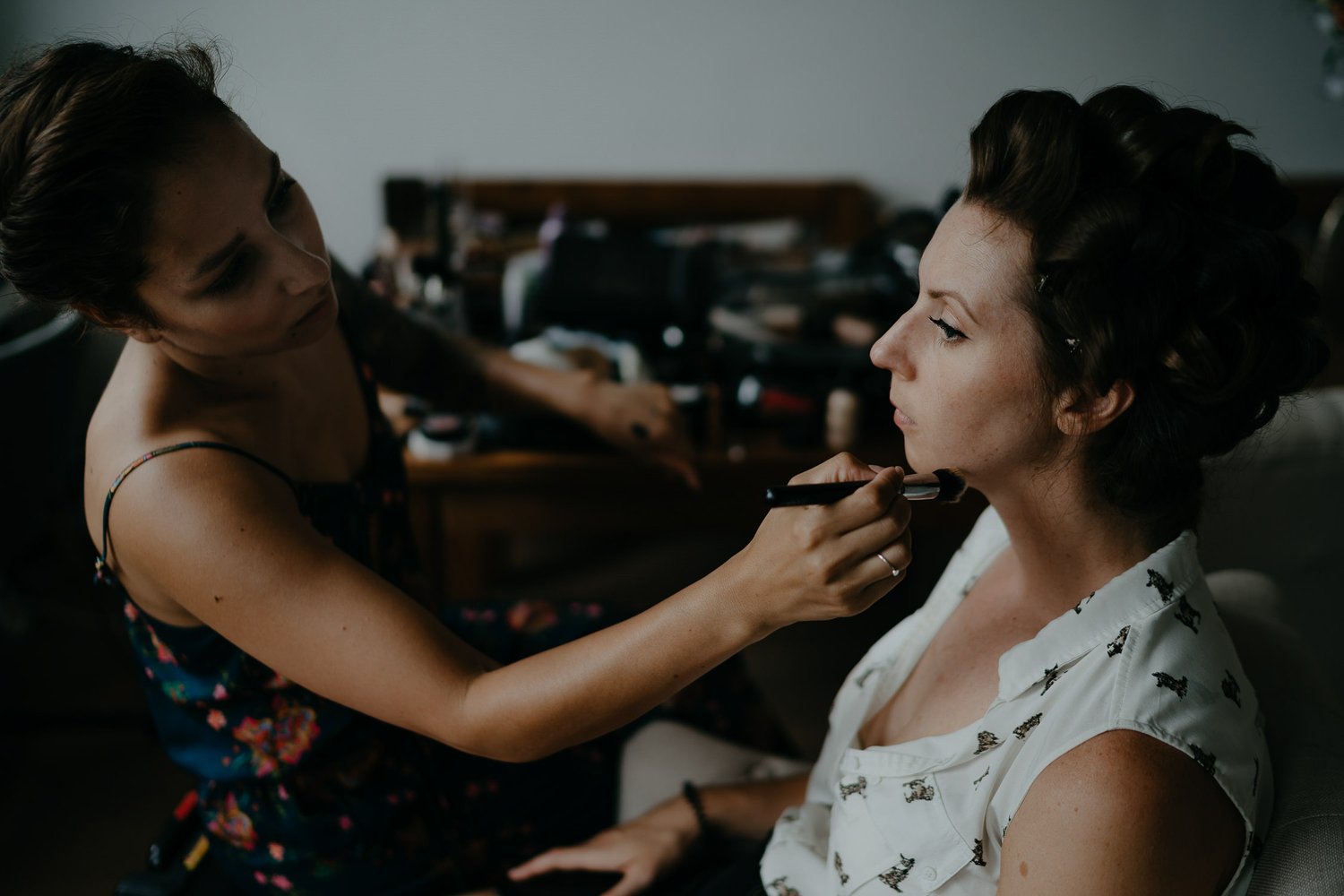 wedding photography bride getting hair and makeup done